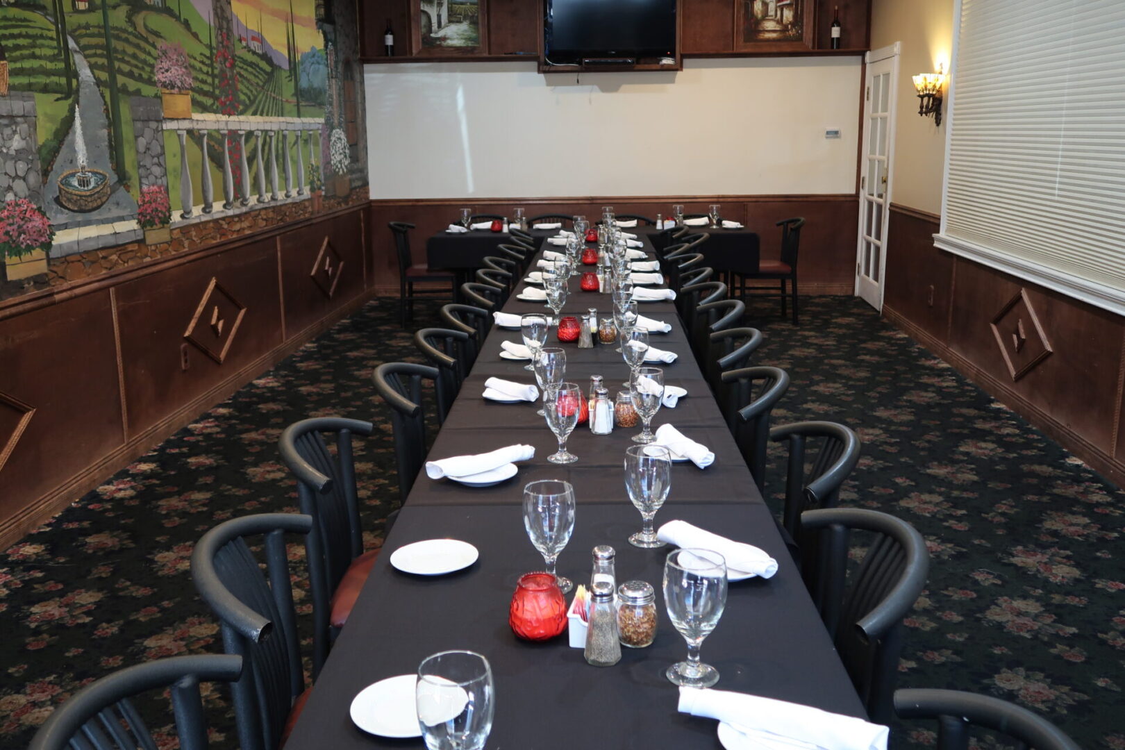 A long table with black cloth and white napkins.